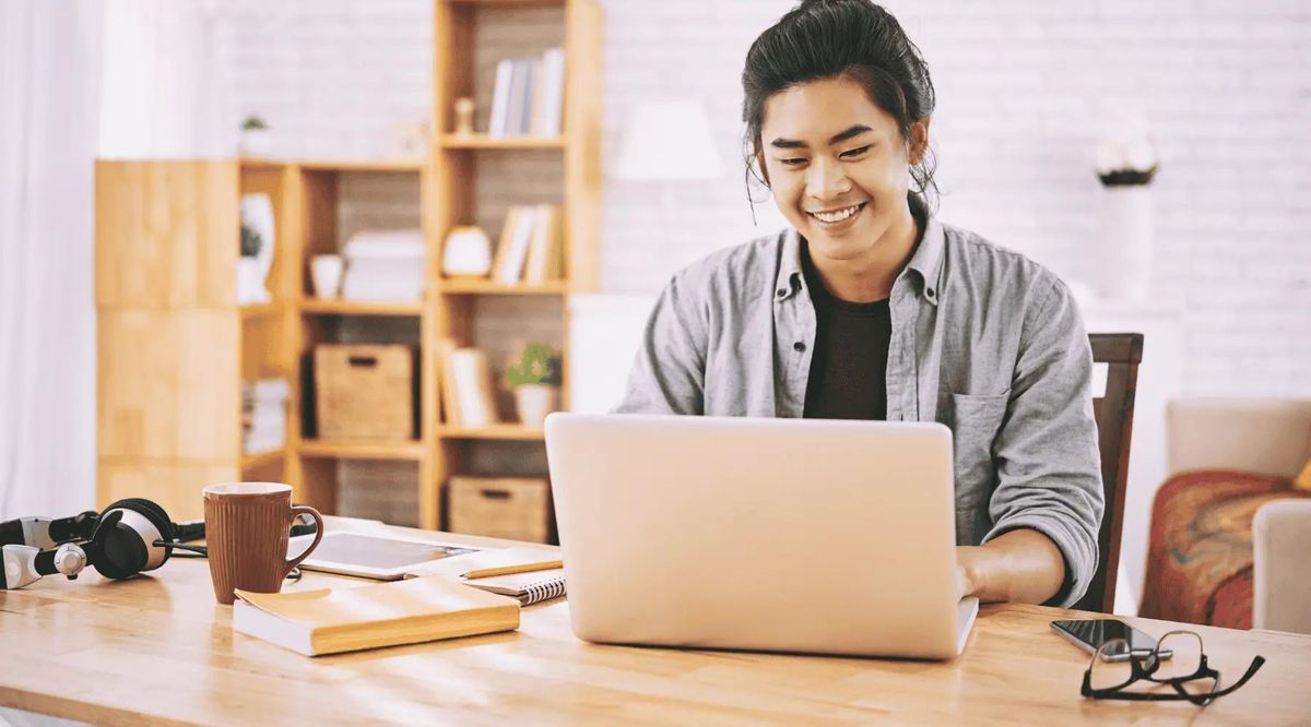 Freelancer working on a laptop at a home desk